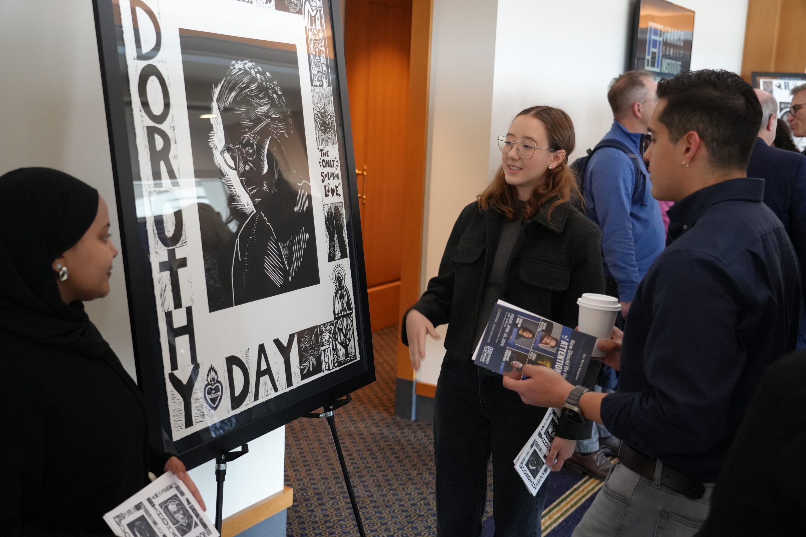 People gather around Dorothy Day mural at Franco Symposium